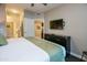 Bedroom featuring a bed, dresser, and access to an ensuite bathroom for convenience at 5450 E Deer Valley Dr # 1176, Phoenix, AZ 85054
