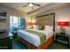 Cozy primary bedroom featuring a king-sized bed and elegant decor at 5450 E Deer Valley Dr # 1176, Phoenix, AZ 85054