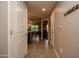 Hallway featuring tile flooring, neutral walls, and a glimpse of the kitchen and dining area at 5450 E Deer Valley Dr # 1176, Phoenix, AZ 85054