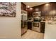 Modern kitchen with stainless steel appliances and dark cabinetry with backsplash at 5450 E Deer Valley Dr # 1176, Phoenix, AZ 85054