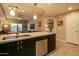 Open concept kitchen with stainless steel appliances, island with sink, and view into the living room at 5450 E Deer Valley Dr # 1176, Phoenix, AZ 85054