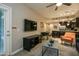 Open-concept living room featuring a modern entertainment center and comfortable seating at 5450 E Deer Valley Dr # 1176, Phoenix, AZ 85054