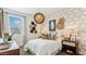 Well-decorated bedroom features a bed with patterned wallpaper, decorative light, and stylish furnishings at 5530 E Mearn Rd, San Tan Valley, AZ 85140