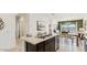 Modern kitchen island with marble countertops, stainless steel sink, and ample cabinet space at 5530 E Mearn Rd, San Tan Valley, AZ 85140