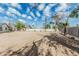 Spacious dirt backyard with mature trees and ample space for outdoor activities and landscaping at 6701 W Monterey Way, Phoenix, AZ 85033