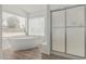 Bathroom features a freestanding tub and separate glass enclosed shower at 6701 W Monterey Way, Phoenix, AZ 85033