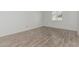 Bedroom with wood-look tile flooring and plenty of natural light at 6701 W Monterey Way, Phoenix, AZ 85033
