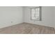 Neutral bedroom with tile floors and bright natural light from window at 6701 W Monterey Way, Phoenix, AZ 85033
