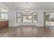 Sun-filled dining room featuring a large bay window and wood-look tile flooring at 6701 W Monterey Way, Phoenix, AZ 85033