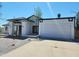 Charming single-story home with white exterior, two car garage and a well-maintained landscaped front yard at 6701 W Monterey Way, Phoenix, AZ 85033