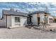 Single-story home with white stucco and brown trim, including a xeriscape yard at 6701 W Monterey Way, Phoenix, AZ 85033
