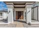 Home featuring an entryway framed by white stucco posts and double doors at 6701 W Monterey Way, Phoenix, AZ 85033
