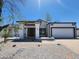 Single-story home featuring neutral paint, a gravel front yard, and attached garage at 6701 W Monterey Way, Phoenix, AZ 85033