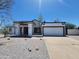 Charming single-story home featuring a well-manicured gravel yard and attached two-car garage at 6701 W Monterey Way, Phoenix, AZ 85033