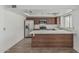Updated kitchen with marble countertops, stainless steel appliances, and wood-look tile flooring at 6701 W Monterey Way, Phoenix, AZ 85033