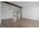 Spacious living room featuring new flooring and white walls at 6701 W Monterey Way, Phoenix, AZ 85033