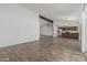 Spacious living room featuring new flooring that flows into the kitchen area at 6701 W Monterey Way, Phoenix, AZ 85033