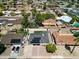 Aerial view of home with solar panels, mature trees, landscaping, and community at 7320 E Pierce St, Scottsdale, AZ 85257
