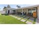 Spacious backyard features a hot tub, pavers, and a covered patio with seating at 7320 E Pierce St, Scottsdale, AZ 85257