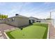 This backyard features a putting green, perfect for golfers and outdoor fun at 7320 E Pierce St, Scottsdale, AZ 85257