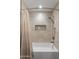 Bright bathroom features a shower over tub and built-in niche with decorative tile work at 7320 E Pierce St, Scottsdale, AZ 85257