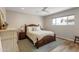 Well-lit bedroom features a ceiling fan, modern window, and stylish decor at 7320 E Pierce St, Scottsdale, AZ 85257
