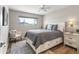 Cozy bedroom with a large window, ceiling fan, stylish furnishings and natural light at 7320 E Pierce St, Scottsdale, AZ 85257