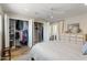 Bedroom featuring an open closet with storage and access to outdoor patio at 7320 E Pierce St, Scottsdale, AZ 85257