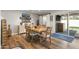 Light-filled dining room with wood table, sliding glass doors to backyard, and coastal decor at 7320 E Pierce St, Scottsdale, AZ 85257