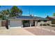 Charming home features solar panels, desert landscaping, and a quaint front porch at 7320 E Pierce St, Scottsdale, AZ 85257