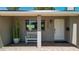Inviting front porch with white bench seating, modern house numbers, desert landscaping and charming brick walkway at 7320 E Pierce St, Scottsdale, AZ 85257