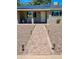 Home features a quaint front walkway, solar panels, desert landscaping, and a bench on the porch at 7320 E Pierce St, Scottsdale, AZ 85257