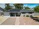 Charming home featuring solar panels, well-kept landscaping, and a welcoming front porch with a bench at 7320 E Pierce St, Scottsdale, AZ 85257