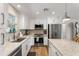 Bright kitchen with white cabinets, granite countertops, and stainless steel appliances at 7320 E Pierce St, Scottsdale, AZ 85257