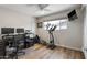 Bright office space with an elliptical machine, desk setup, and natural light at 7320 E Pierce St, Scottsdale, AZ 85257