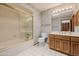 The bathroom features a vanity, tub with shower, and patterned wallpaper at 7615 E Tucson Rd, Scottsdale, AZ 85258