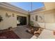 Inviting courtyard with decorative rocks, mature landscaping and exterior building with art and storage at 7615 E Tucson Rd, Scottsdale, AZ 85258