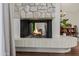 Inviting fireplace with stone surround and hearth, creating a cozy and warm atmosphere at 7615 E Tucson Rd, Scottsdale, AZ 85258