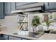 Modern kitchen with a flat cooktop and view to adjacent eat-in kitchen at 7615 E Tucson Rd, Scottsdale, AZ 85258