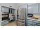 Kitchen featuring stainless steel refrigerator and blue cabinets at 7615 E Tucson Rd, Scottsdale, AZ 85258