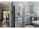 Kitchen featuring stainless steel refrigerator and shaker style cabinets at 7615 E Tucson Rd, Scottsdale, AZ 85258