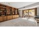 Cozy living room features custom built-in shelving and an outdoor patio with bi-fold doors at 7615 E Tucson Rd, Scottsdale, AZ 85258