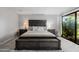 Comfortable main bedroom with a queen bed, side tables, and access to a patio at 7615 E Tucson Rd, Scottsdale, AZ 85258