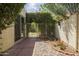 Charming backyard area with a small garden, a gated entryway, and privacy landscaping at 7714 N 17Th Pl, Phoenix, AZ 85020
