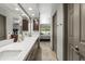 Bathroom featuring double sinks, white countertops, and dark wood cabinetry at 7714 N 17Th Pl, Phoenix, AZ 85020