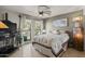 Bright bedroom featuring a ceiling fan, tile floors, and a large window at 7714 N 17Th Pl, Phoenix, AZ 85020