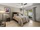 Cozy bedroom featuring tile floors, a ceiling fan, and a sliding glass door to the patio at 7714 N 17Th Pl, Phoenix, AZ 85020