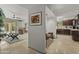 Open floor plan with travertine flooring featuring a living room and kitchen with dark wood cabinets at 7714 N 17Th Pl, Phoenix, AZ 85020