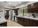Bright kitchen with stainless steel appliances, a view to the backyard, and dark cabinetry at 7714 N 17Th Pl, Phoenix, AZ 85020