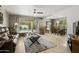 An open-concept living room next to a dining area and a view of the outdoor pool area at 7714 N 17Th Pl, Phoenix, AZ 85020